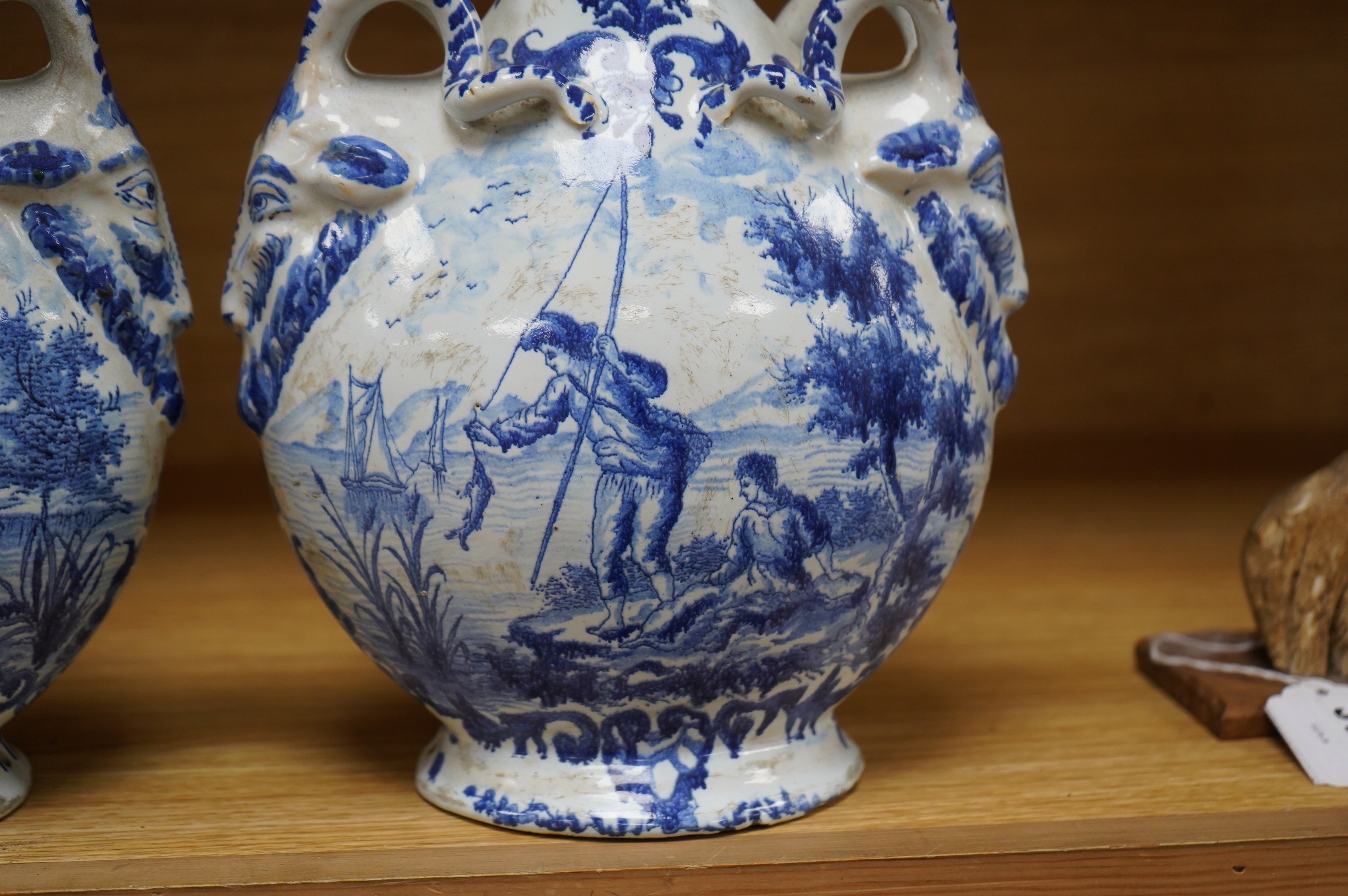 A pair of mid 18th century Delft blue and white flagons